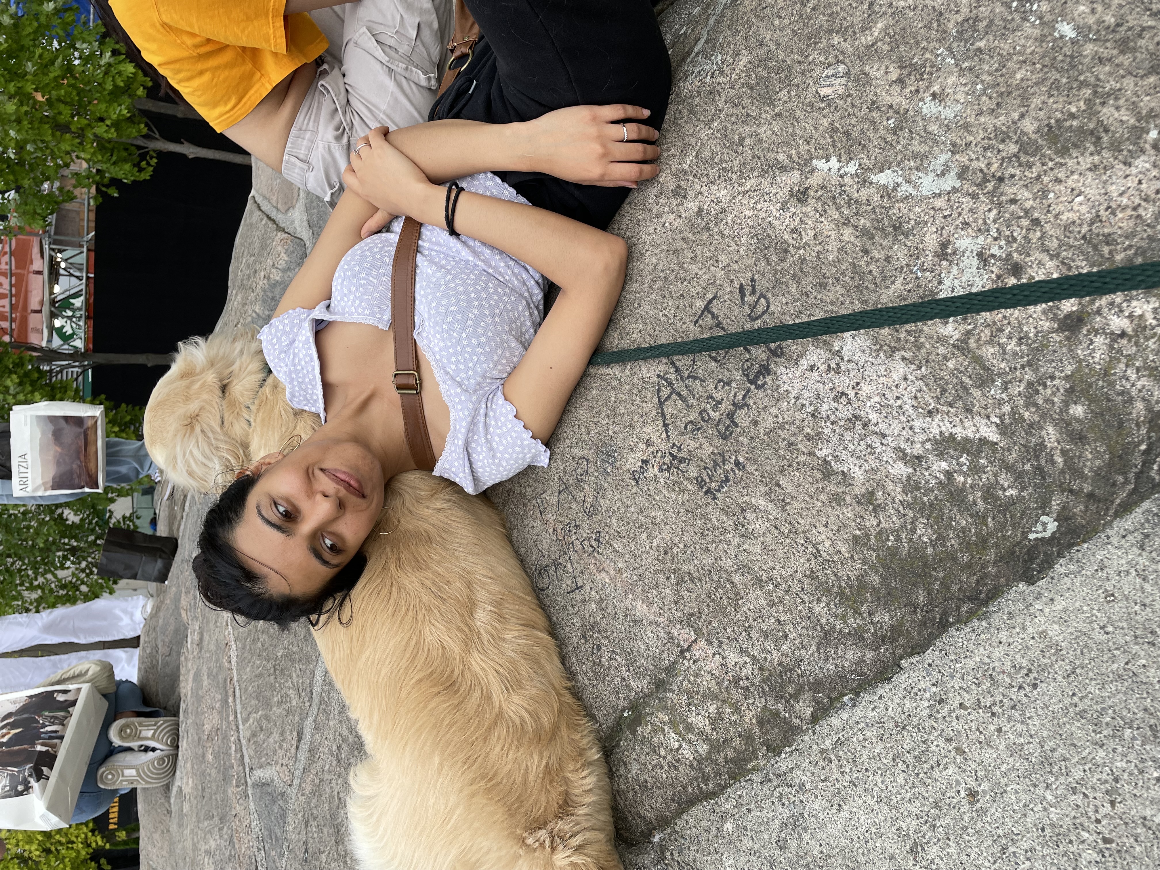 Astha sharing a relaxed moment with a dog